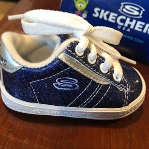 New with box baby blue glittery Skechers Sneakers.